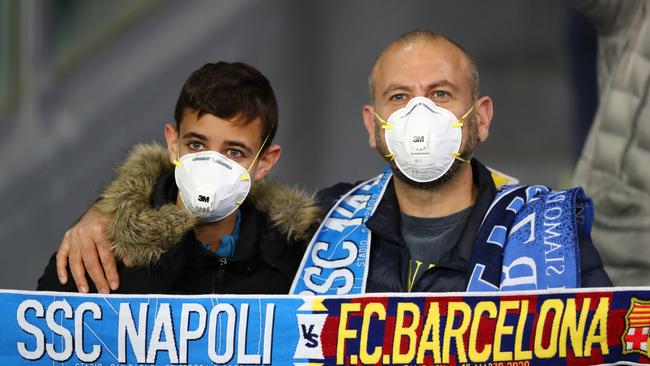 Fans wear medical face masks at the UEFA Champions League round of 16 first leg match between SSC Napoli and FC Barcelona at Stadio San Paolo in Naples, Italy. Picture: Getty Images