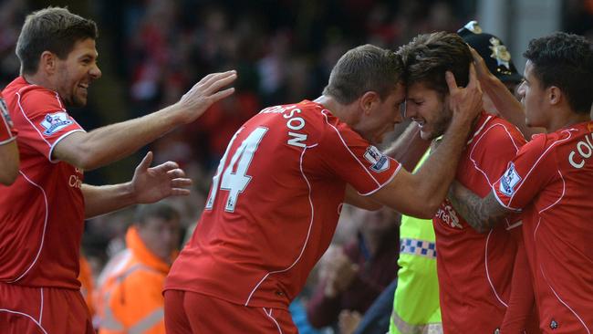 Gerrard and Henderson celebrate Adam Lallana’s goal.