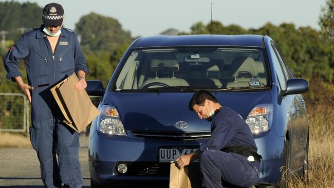 Police bag evidence after locating Herman Rockefeller’s car.