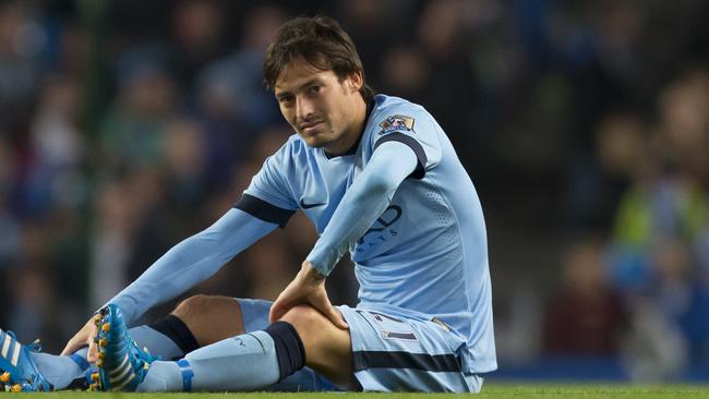 Manchester City's David Silva sits on the pitch after being injured during the English League Cup soccer match between Manchester City and Newcastle at the Etihad Stadium, Manchester, England, Wednesday Oct. 29, 2014. (AP Photo/Jon Super)