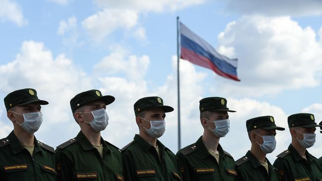 Russian servicemen wear face masks while standing at attention. Picture: AFP