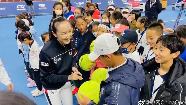 Peng Shuai signs autographs balls at a junior tennis tournament in Beijing on Sunday. Picture: Reuters.