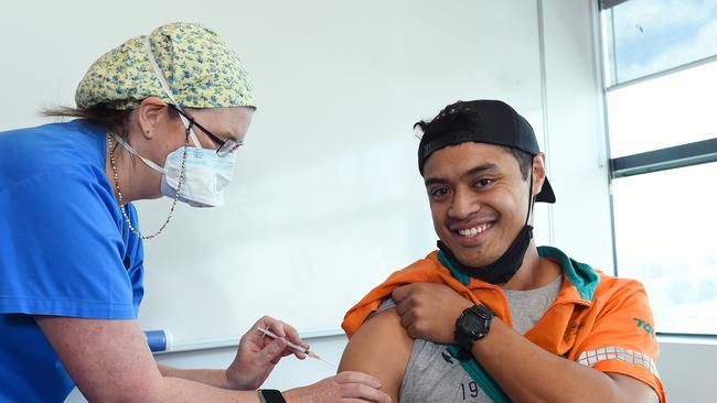 Toll worker Jonathan Toetu gets a vaccine at the Kmart distribution centre in Truganina, operated by Toll. Picture: Josie Hayden