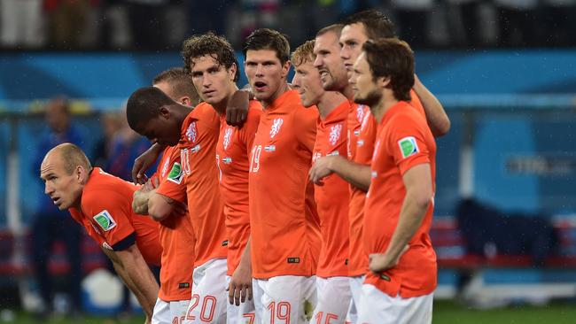 Netherlands' forward Arjen Robben (L) looks on with teammates.