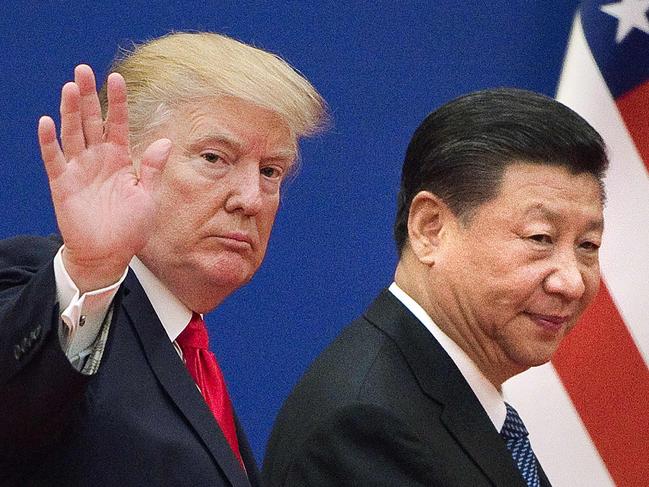 (FILES) In this file photo US President Donald Trump (L) and China's President Xi Jinping leave a business leaders event at the Great Hall of the People in Beijing on November 9, 2017. - Donald Trump pleaded with China's leader Xi Jinping for help to win re-election in 2020, the US president's former aide John Bolton writes in an explosive new book, according to excerpts published June 17. (Photo by Nicolas ASFOURI / AFP)