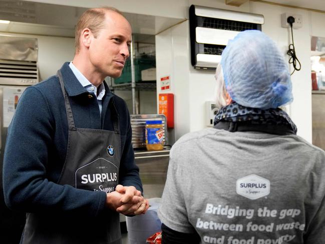The prince was a hit with workers at the food charity. Picture: AFP