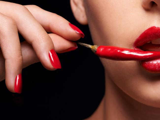 RendezView. Woman holding a red chilli to her mouth. (Pic: iStock)