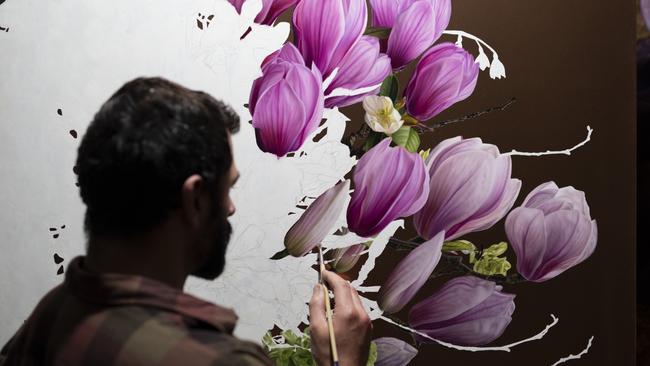 Tasmanian artist Sebastian Galloway paints magnolias on copper in preparation for his upcoming exhibition at Hobart's Handmark Gallery. For TasWeekend. Picture: Supplied