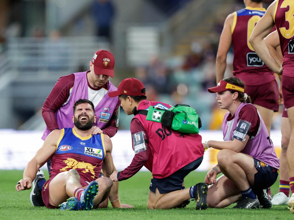 Marcus Adams is assisted by Brisbane Lions’ medical staff after suffering a heavy knock against Carlton last year. Picture: Russell Freeman/AFL Photos via Getty Images