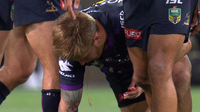 Cameron Munster spits blood after a head clash.