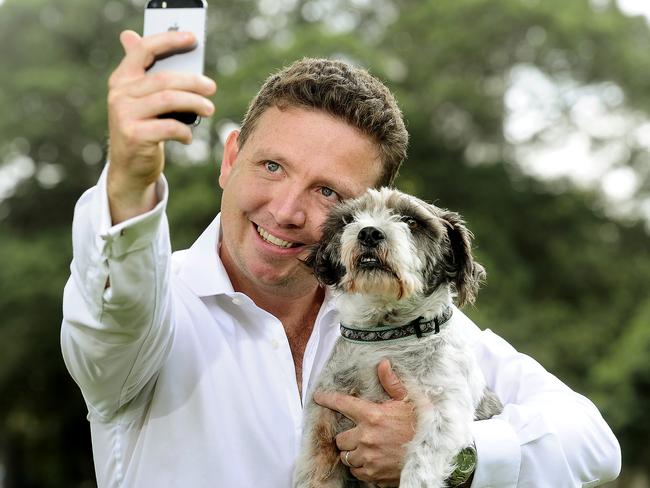 This one’s for your Facebook page: PetCircle.com.au founder Mike Frizell with office dog Diesel. Picture: John Appleyard