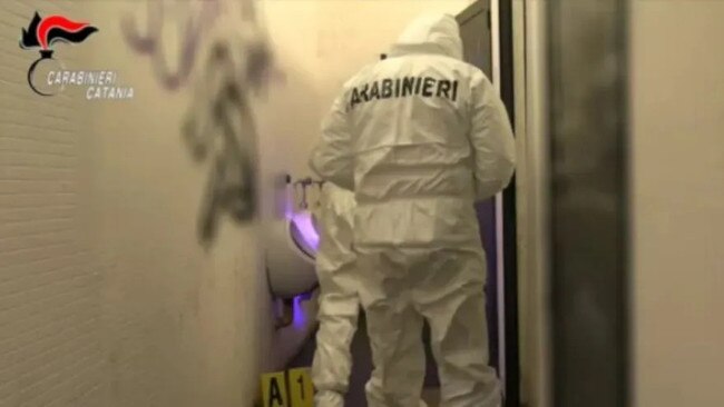 Investigators at the scene of the crime in a public toilet in Catania. Picture: Carabinieri Catania