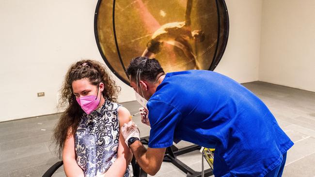 A young woman is vaccinated in front of works of modern art at the MuMe-Museo Regionale during VACCINArte's ‘discover, get excited and get vaccinated’ event - an idea to promote the vaccination campaign and the artistic heritage at the same time, transforming some museums into vaccination hubs for a day, in Messina, Italy. Picture: Getty