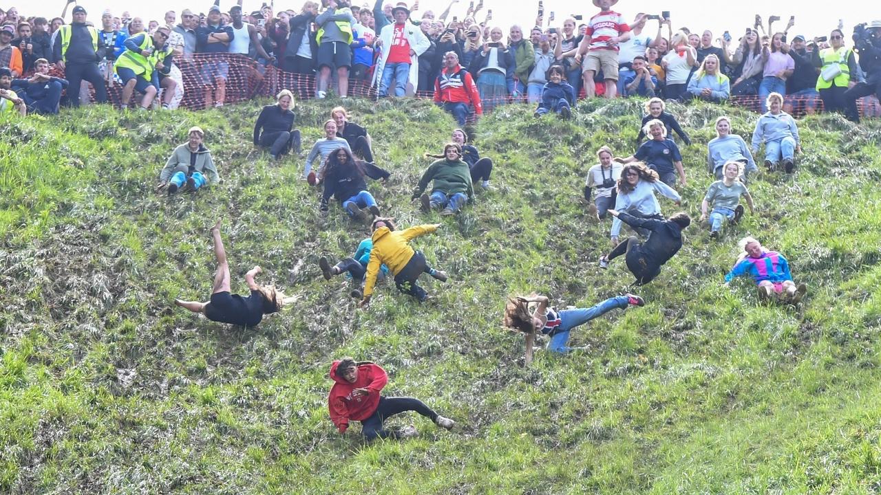 Female competitors fling themselves down the steep hill in pursuit of the cheese wheel. Picture: Jules Annan / BACKGRID