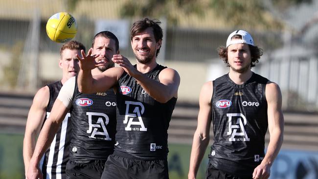 Sam Mayes is all smiles after getting his first opportunity with Port. Travis Boak and Riley Grundy behind him. Picture: Sarah Reed