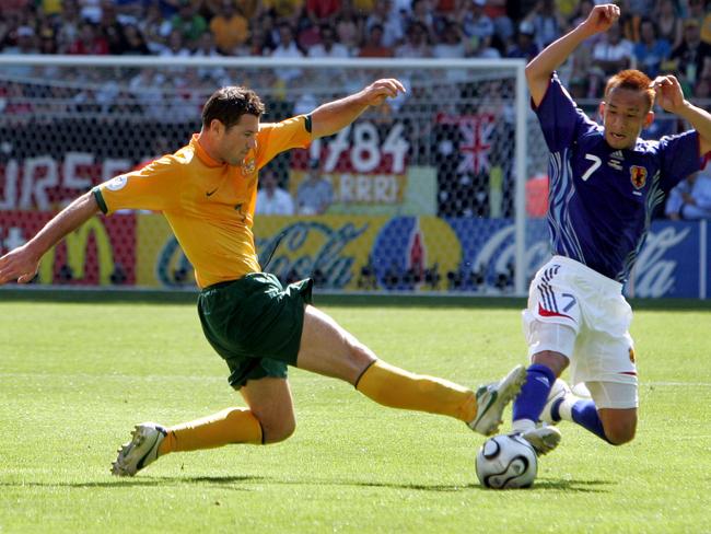 Brett Emerton (L) vies with Hidetoshi Nakata during the opening round Group F World Cup soccer match at Kaiserslautern's Fritz-Walter Stadium