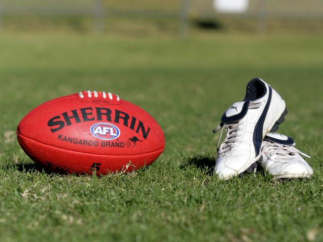 Generic AFL Sherrin football and football boots. sport /