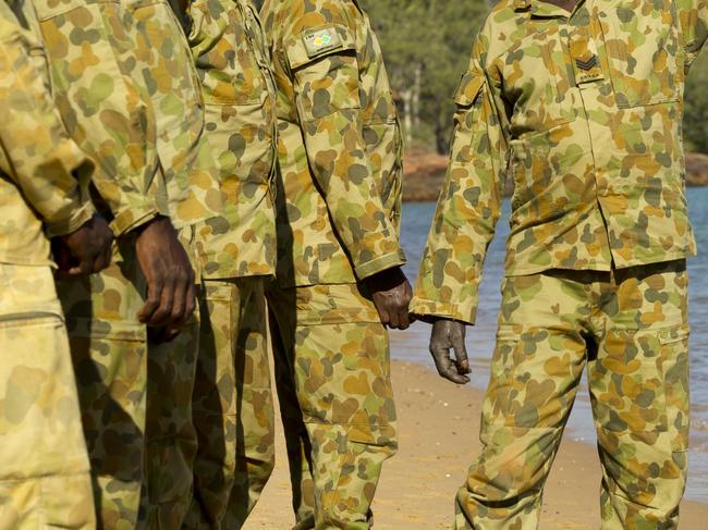 Australian Army soldier Sergeant Tommy Munyarryun (right) indicates areas of historical significance to other members of Arnhem Squadron, North-West Mobile Force (NORFORCE), at Caledon Bay, Northern Territory, during a study tour in September 2014. *** Local Caption *** Australian Army soldiers from Arnhem Squadron, North-West Mobile Force (NORFORCE), undertook a study tour to Caledon Bay, Northern Territory, in September 2014.   Caledon Bay is the site where Donald Thomson trained Indigenous men as members of the Northern Territory Special Reconnaissance Unit (NTSRU) during World War II. The NTSRU patrolled Arnhem Land and trained as guerrillas in case of invasion.   Local girl Nyesha found part of a Royal Australian Air Force uniform on the Caledon Bay beach in July 2014. Many members of today’s Arnhem Squadron have direct family links to the members of the NTSRU.  Following a request from the Prime Minister, The Hon. Tony Abbott, MP, the Australian Defence Force provided logistical support to the Prime Minister’s visit to Arnhem Land to spend a week engaging with local Indigenous communities and community leaders in September 2014.  Elements of 10th Force Support Battalion provided catering and logistical services to establish a camp at the Gulkala, the site of the annual Garma festival in the Northern Territory, for up to 150 people.  During the visit the Prime Minister observed elements of the North-West Mobile Force (NORFORCE) during a training activity and participated in a memorial service to Indigenous soldiers who served in the Northern Territory in World War II.   NORFORCE is an Australian Army infantry regiment. The primary role of NORFORCE is reconnaissance, surveillance and community engagement throughout the Northern Territory and the Kimberley region of Western Australia. The unit’s 500 soldiers include 440 reservists, of whom around half are Indigenous. The unit conducts long-range patrols, drawing heavily on the skills and local knowledge of these Indigenous patrolmen.