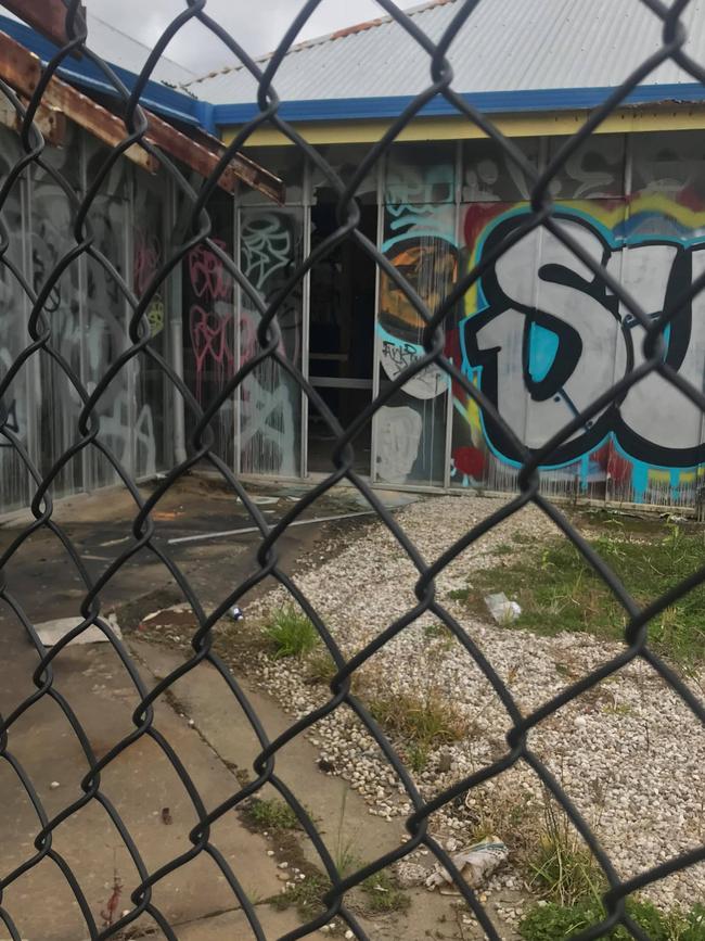 The buildings are covered in graffiti.