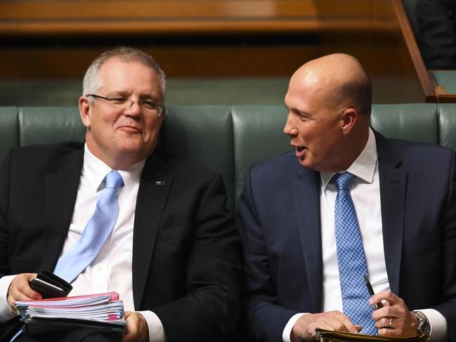 Treasurer Scott Morrison and Home Affairs Minister Peter Dutton share a laugh on Monday. Picture: AAP