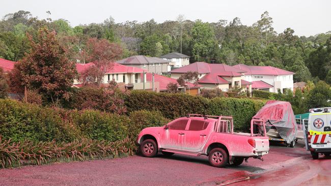 Red fire retardant covers homes and vehicles in South Turrumurra. Picture: John Grainger