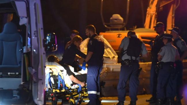 An injured man waits to be taken to hospital. Picture: Dean Asher