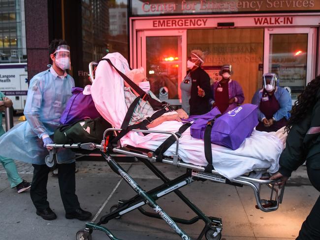 NEW YORK, NY - APRIL 30 : An older man is wheeled towards an ambulance on April 30, 2020 at NYU Langone Hospital in New York City. With over 304,000 confirmed cases and over 18,000 deaths, New York City has been the epicenter of coronavirus deaths.   Stephanie Keith/Getty Images/AFP == FOR NEWSPAPERS, INTERNET, TELCOS & TELEVISION USE ONLY ==