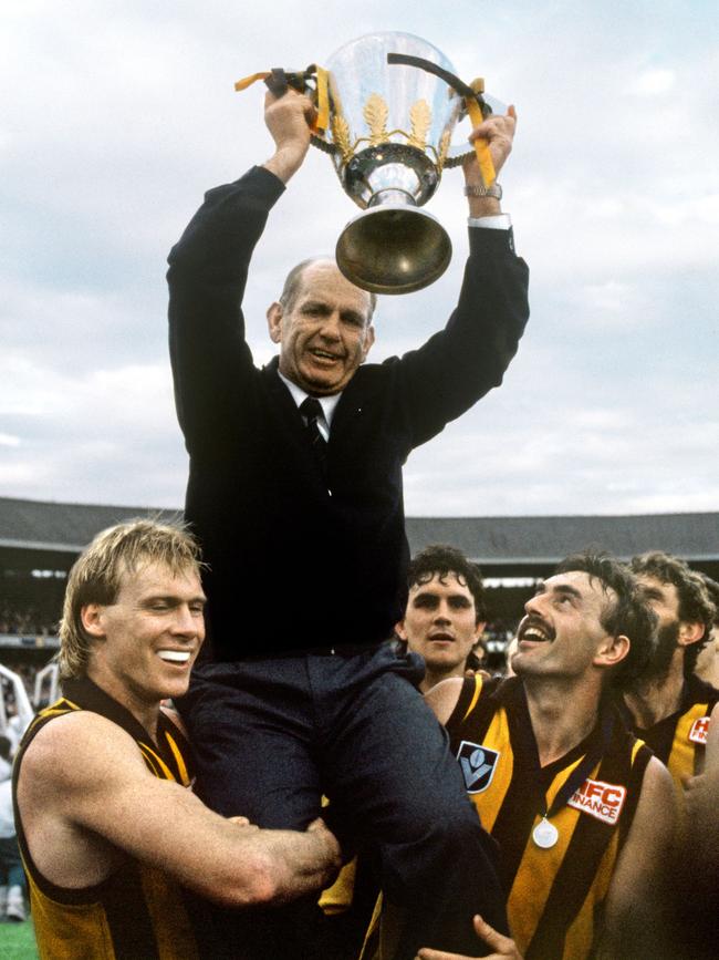 Hawthorn coach Allan Jeans holds up the 1989 premiership cup.