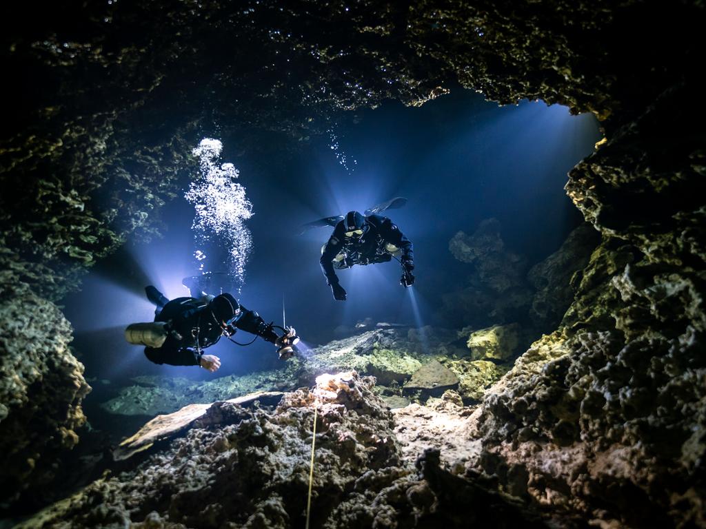 Divers exploring a cave. Picture: Alice Bennett/Underwater Photographer of the Year Awards 2021