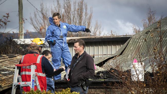 Police and fire investigators at the scene of a house fire at Fourfoot Rd, Geeveston. Picture Chris Kidd