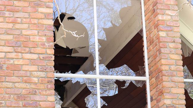 Broken windows at the property. Picture: AAP/Jono Searle