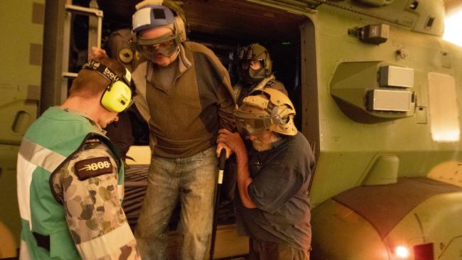 Frank Delaney and Warren Usher are helped from a military support helicopter. Picture: ADF