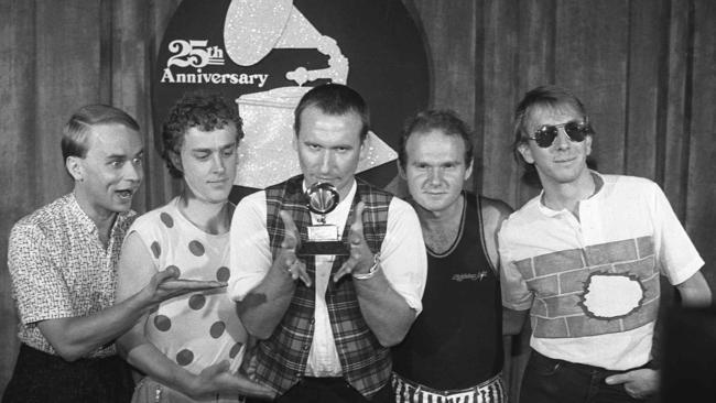 Men at Work pose with their Grammy Award for best new artist in Los Angeles, February 1983. From left: Greg Hamm, Ron Strykert, Colin Hay, Jerry Speiser and John Rees. Picture: file