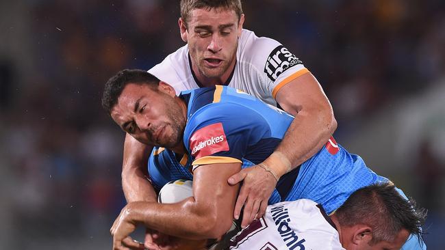 Titans prop Ryan James takes on the Broncos defence.