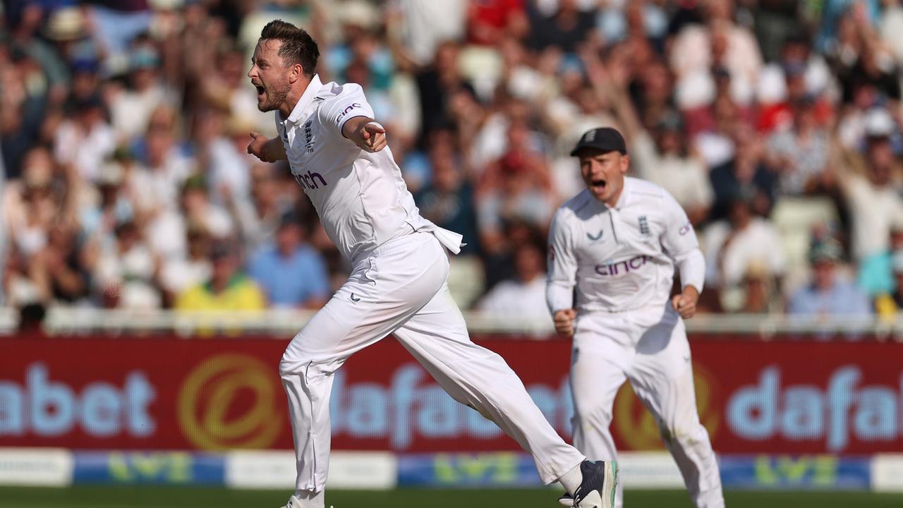 Ollie Robinson of England celebrates after taking the wicket of David Warner. (Photo by Ryan Pierse/Getty Images)