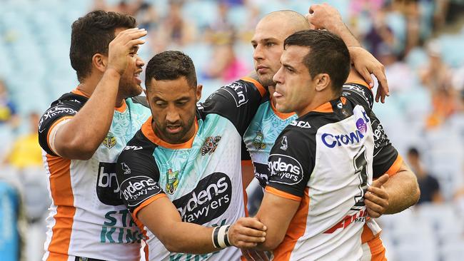 Robbie Rochow celebrates scoring a try with his Tigers teammates.