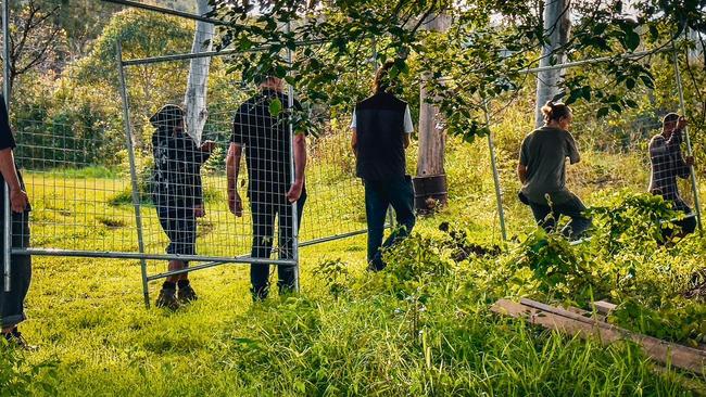 A community vigil to remove fencing and allow those without a home to occupy an abandoned buyback home in North Lismore. Picture: Cath Piltz