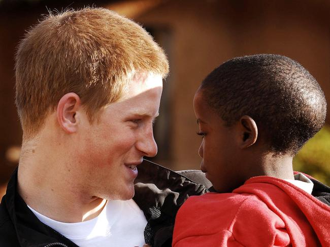 Harry meets his old friend, Mutsu Potsane, 6, in the grounds of Mants'ase children's home two years later in 2006 while on a return visit to Lesotho in Southern Africa. Picture: AFP