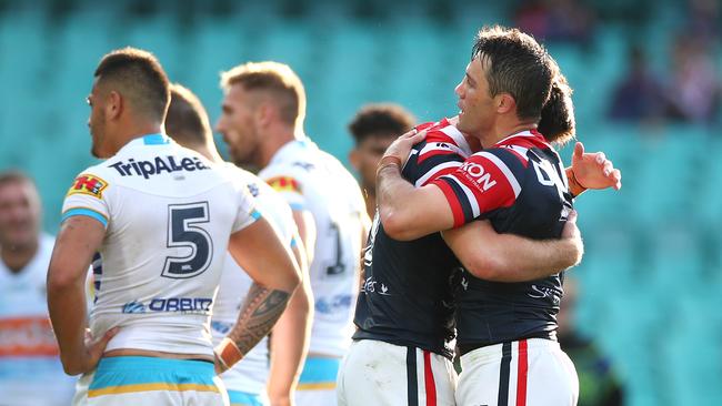 Titans players including Phillip Sami look dejected as the Roosters celebrate another try in their 58-6 win. Picture: Getty Images