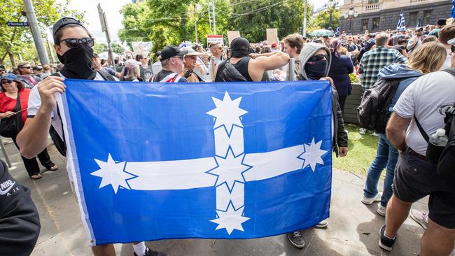 Protesters brought flags and signs to the rally. Picture: Jason Edwards