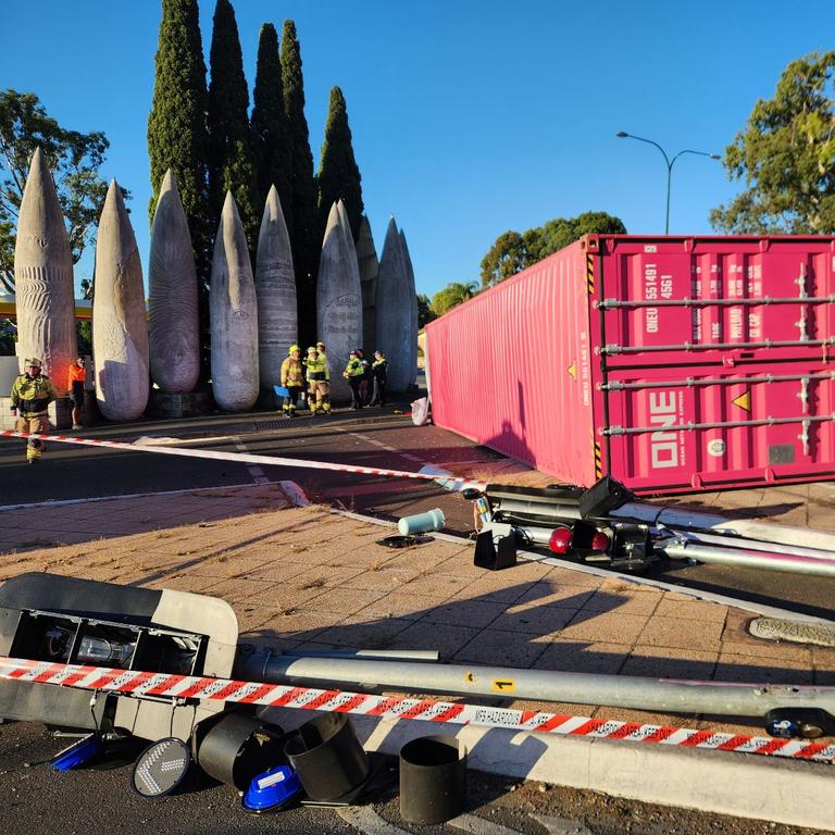 The truck rollover caused extensive damage to traffic lights.