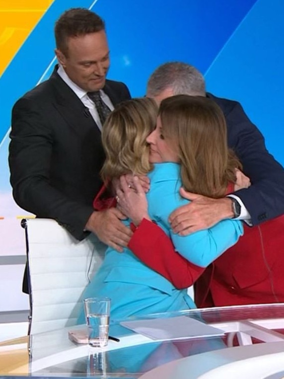 … And gets comforted by her colleagues.