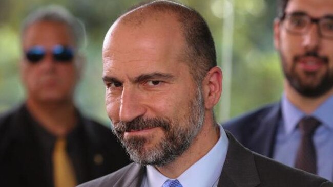 UBER's CEO Dara Khosrowshahi (R) smiles after meeting with Brazilian Finance Minister Henrique Meirelles (out of frame) in Brasilia, Brazil on October 31, 2017. / AFP PHOTO / Sergio LIMA