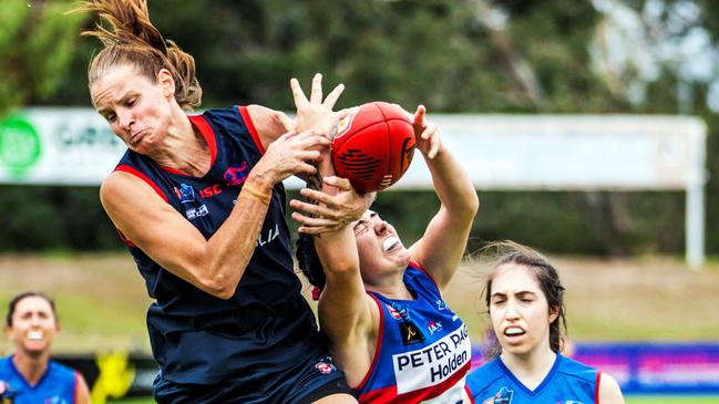 Norwood's Jo Hill in a fiercely contested mark with Central District's Abbie Scheer. Picture: Peter Argent