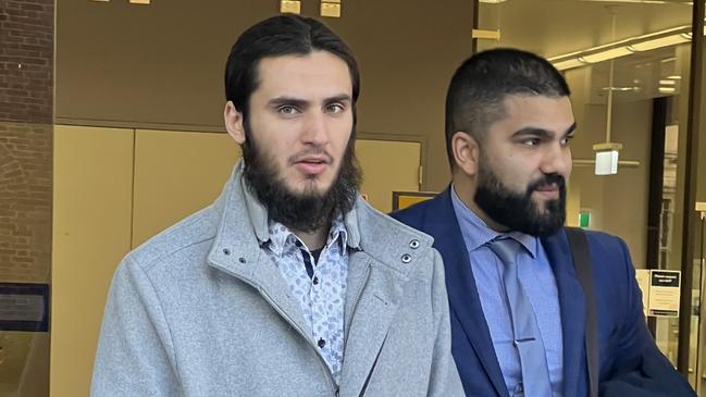 Alleged ISIS member Joseph Saadieh (pictured left, in grey coat)​ leaves Parramatta courthouse on Friday after being committed to stand trial on a single terrorism charge.