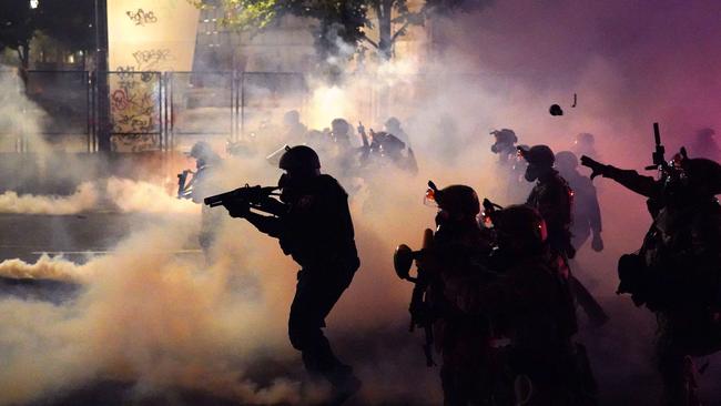 Federal officers deploy tear gas and less-lethal munitions while dispersing a crowd of about a thousand protesters in front of the Mark O. Hatfield US Courthouse in Portland, Oregon. Picture: AFP