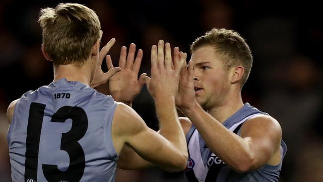 Dan Houston (right) celebrates one of his two goals against Essendon with teammate Todd Marshall. Picture: MARK DADSWELL (AAP).