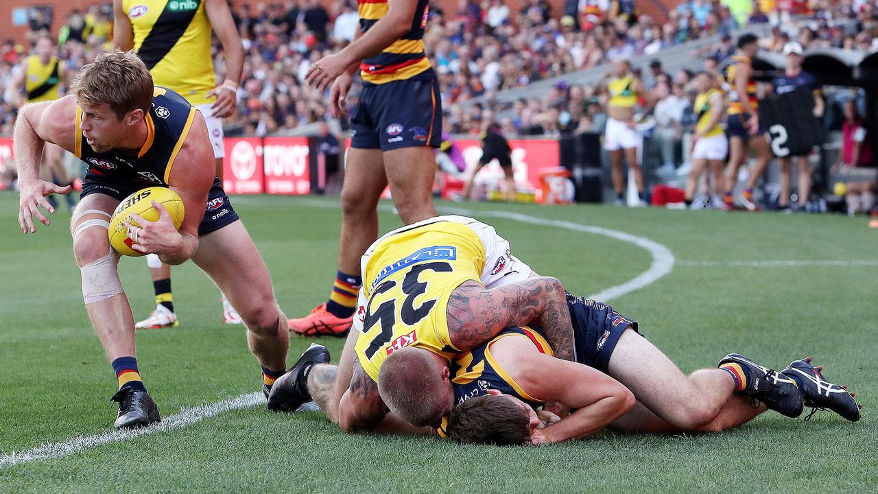 Patrick Parnell of the Crows is tackled by Nathan Broad of the Tigers. (Photo by Sarah Reed/AFL Photos via Getty Images)