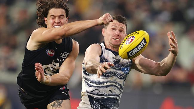 Liam Stocker gets a fist in to cut of the ball directed to Patrick Dangerfield. Picture: Michael Klein