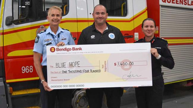 SIGNED, SEALED, DELIVERED: Senior Sergeant Kim Cavell and QFES Acting Assistant Commissioner Michelle Young present Andrew Ayres with a $1400 cheque. Picture: Eden Boyd